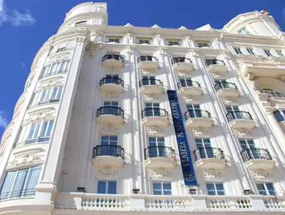 a tall white building with balconies on it at Venecia Plaza Centro in Valencia