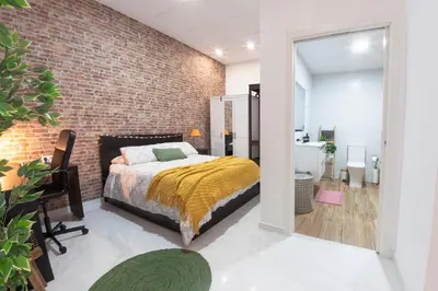 a bedroom with a bed and a brick wall at Digital Nomad Retreat 2 -Great Location Near Metro in Valencia