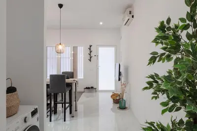 a white living room with a table and a potted plant at Digital Nomad Retreat 2 -Great Location Near Metro in Valencia