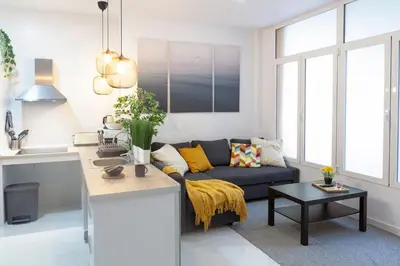 a living room with a blue couch and a table at Artistic Digital Retreat-Great Location Near Metro in Valencia
