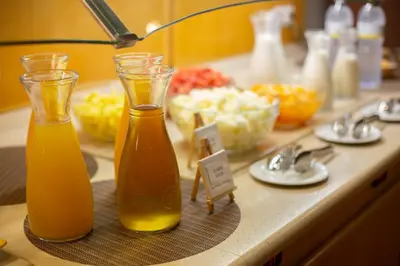 two bottles of orange juice sitting on a counter at Flag Hotel Valencia in Masalfasar