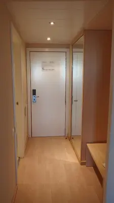 a hallway with a large white door and a mirror at Flag Hotel Valencia in Masalfasar