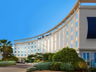 a large white building with people on top of it at Flag Hotel Valencia in Masalfasar