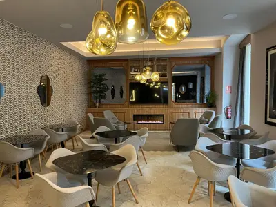 a restaurant with tables and chairs and a fireplace at SH Ingles Boutique Hotel in Valencia