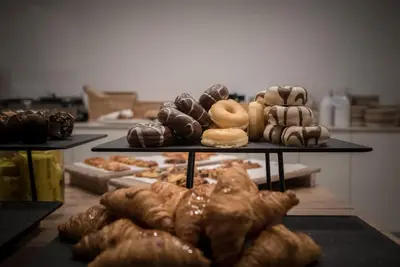 a display of different types of donuts and pastries at SH Ingles Boutique Hotel in Valencia