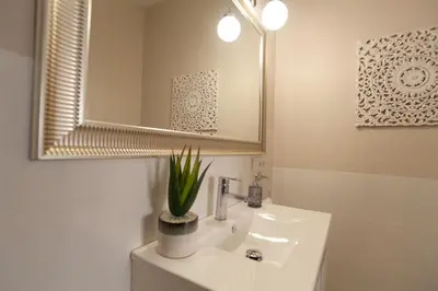 a white bathroom with a sink and a mirror at MD Patacona Beach Mid-term in Valencia