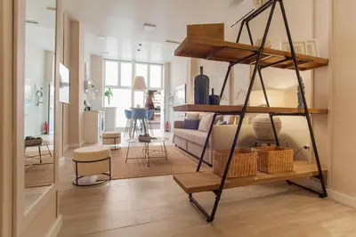 a living room with a book shelf and a living room at MD Patacona Beach Mid-term in Valencia