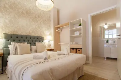 a bedroom with a large bed with a large headboard at MD Patacona Beach Mid-term in Valencia