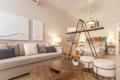 a living room with a couch and a table at MD Patacona Beach Mid-term in Valencia