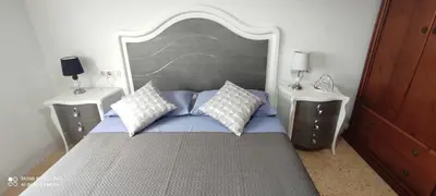 a bedroom with a large bed with two night stands at Gracioso apartamento en Massanassa in Benetúser