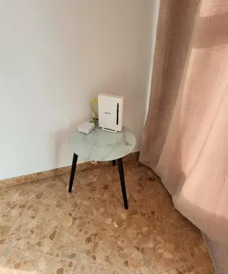 a small table with a laptop on top of it at Magnifico apartamento en Burriana in Burriana