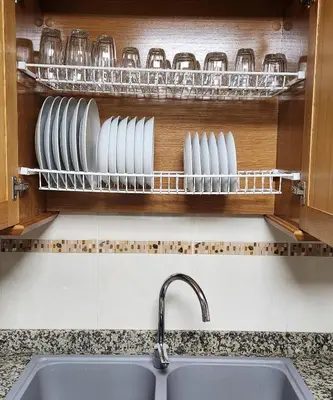 a kitchen with a sink and plates on a shelf at Magnifico apartamento en Burriana in Burriana