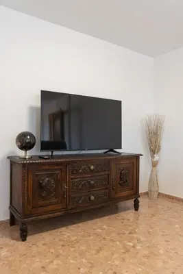 a wooden entertainment center with a flat screen tv on top at Magnifico apartamento en Burriana in Burriana