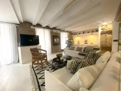 a living room with a white couch and a tv at Valencia Luxury - Boutique El Carmen in Valencia