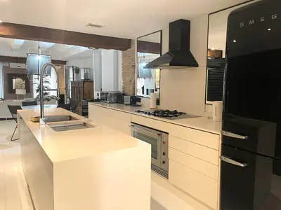 a kitchen with white counters and a black refrigerator at Valencia Luxury - Boutique El Carmen in Valencia