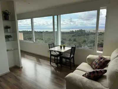 a living room with a table and chairs and large windows at Spacious Apartment in Valencia with Sea View - 160 sqm in Valencia
