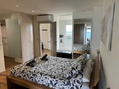a bedroom with a bed with a black and white comforter at Spacious Apartment in Valencia with Sea View - 160 sqm in Valencia