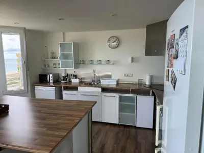 a kitchen with white appliances and a clock on the wall at Spacious Apartment in Valencia with Sea View - 160 sqm in Valencia