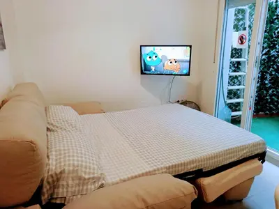 a living room with a couch and a flat screen tv at Apartamento en la playa las arenas +Wifi+AC in Valencia