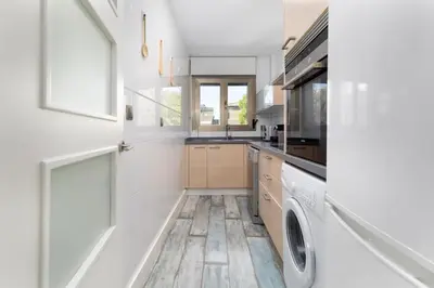 a kitchen with white walls and a washer and dryer at ApartUP Patacona Azzure in Valencia