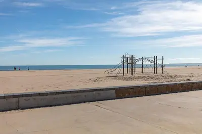 an empty playground on a beach near the ocean at ApartUP Patacona Azzure in Valencia