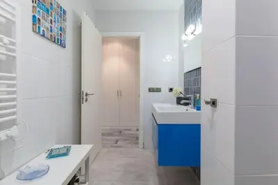a bathroom with a sink and a blue cabinet at ApartUP Patacona Azzure in Valencia