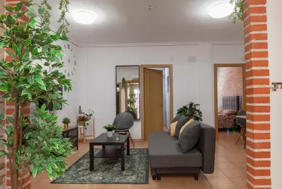 a living room with a couch and a table at Artsy Large Getaway - 2 Bedroom w HUGE patio - Great for families and Digital Nomads in Valencia