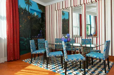a dining room with a table and blue chairs at The Westin Valencia in Valencia