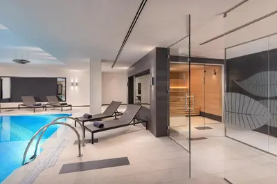 a living room with a swimming pool and a house at The Westin Valencia in Valencia