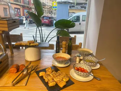 a table topped with bowls and plates of food at YOU & CO. J. Botánico Boutique in Valencia