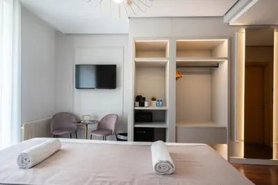 a bedroom with a bed with two towels on it at YOU & CO. J. Botánico Boutique in Valencia