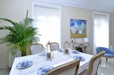 a dining room with a white table with blue and white dishes at Joaquín Sorolla in Valencia
