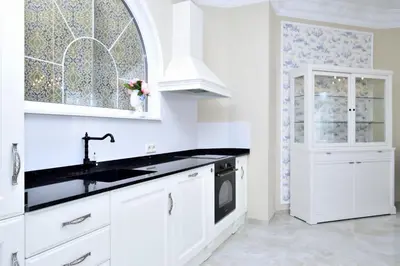a white kitchen with a sink and a window at Joaquín Sorolla in Valencia