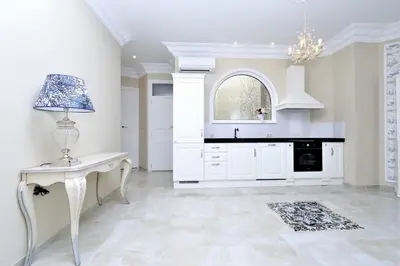 a white kitchen with a table and a lamp at Joaquín Sorolla in Valencia