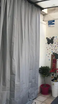 a white curtain in a room with a butterfly on the wall at Habitación Apartamento Suite Papillon in Valencia