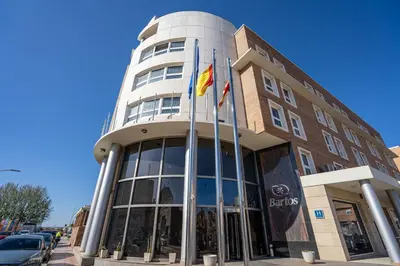 a building with two flags in front of it at Hotel Bartos in Almussafes
