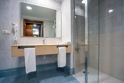 a bathroom with a sink and a shower at Hotel Bartos in Almussafes