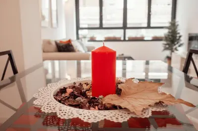 a red candle sitting on top of a table at Hogar moderno cerca de Casco Antiguo de Valencia in Valencia