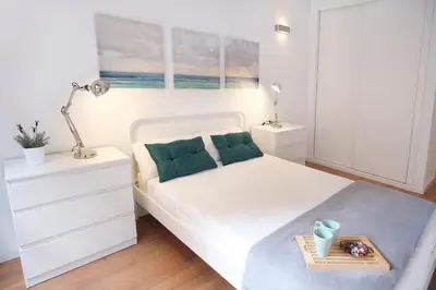 a bedroom with a white bed with a tray on it at Hogar moderno cerca de Casco Antiguo de Valencia in Valencia
