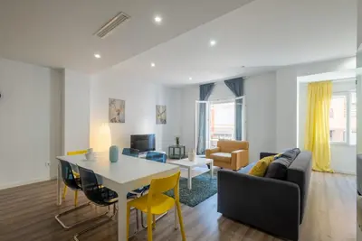 a living room with a table and a couch at Modern, Stylish Apartment with balcony in Valencia