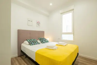 a bedroom with a bed with two towels on it at Modern, Stylish Apartment with balcony in Valencia