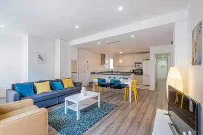 a living room with a blue couch and a table at Modern, Stylish Apartment with balcony in Valencia