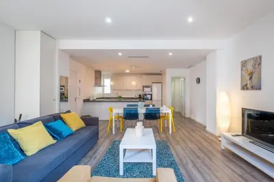 a living room with a blue couch and a table at Modern, Stylish Apartment with balcony in Valencia