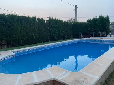 a large blue swimming pool in a yard at Encantador alojamiento con acceso a piscina compartida in Monserrat