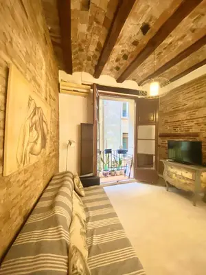 a living room with a couch and a television at Your Valencia Home in Valencia