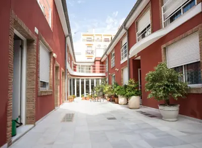 an empty alley with potted plants and buildings at Hotel Casbah in El Puig