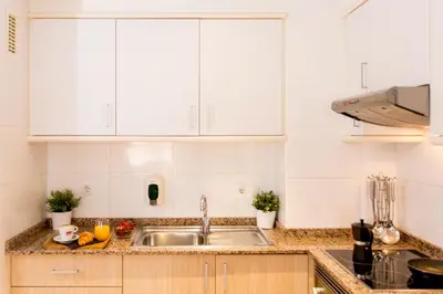a kitchen with white cabinets and a sink at Valenciaflats Ciudad de las Ciencias in Valencia