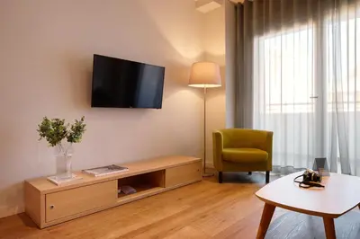 a living room with a flat screen tv on the wall at Valenciaflats Ciudad de las Ciencias in Valencia