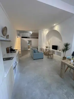 a large kitchen and living room with a blue couch at Maravilloso Loft junto a Ciudad de Artes y Ciencia in Valencia