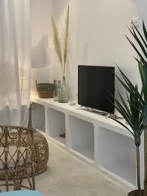 a living room with a tv on a white desk at Maravilloso Loft junto a Ciudad de Artes y Ciencia in Valencia